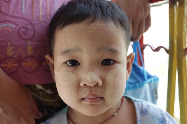 A boy with thanakha on his cheeks